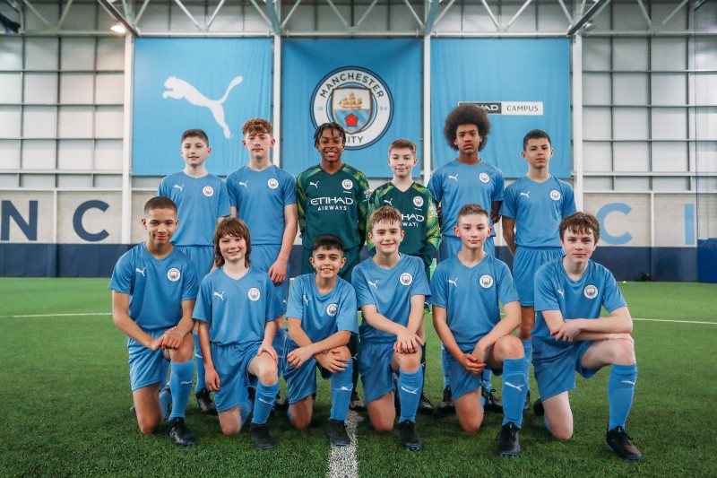 A team photo at Manchester City Football School.